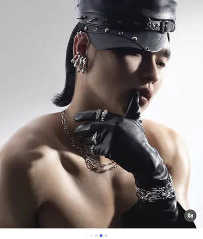 Model wearing Posthuman Lab chain jewelry and a leather cap