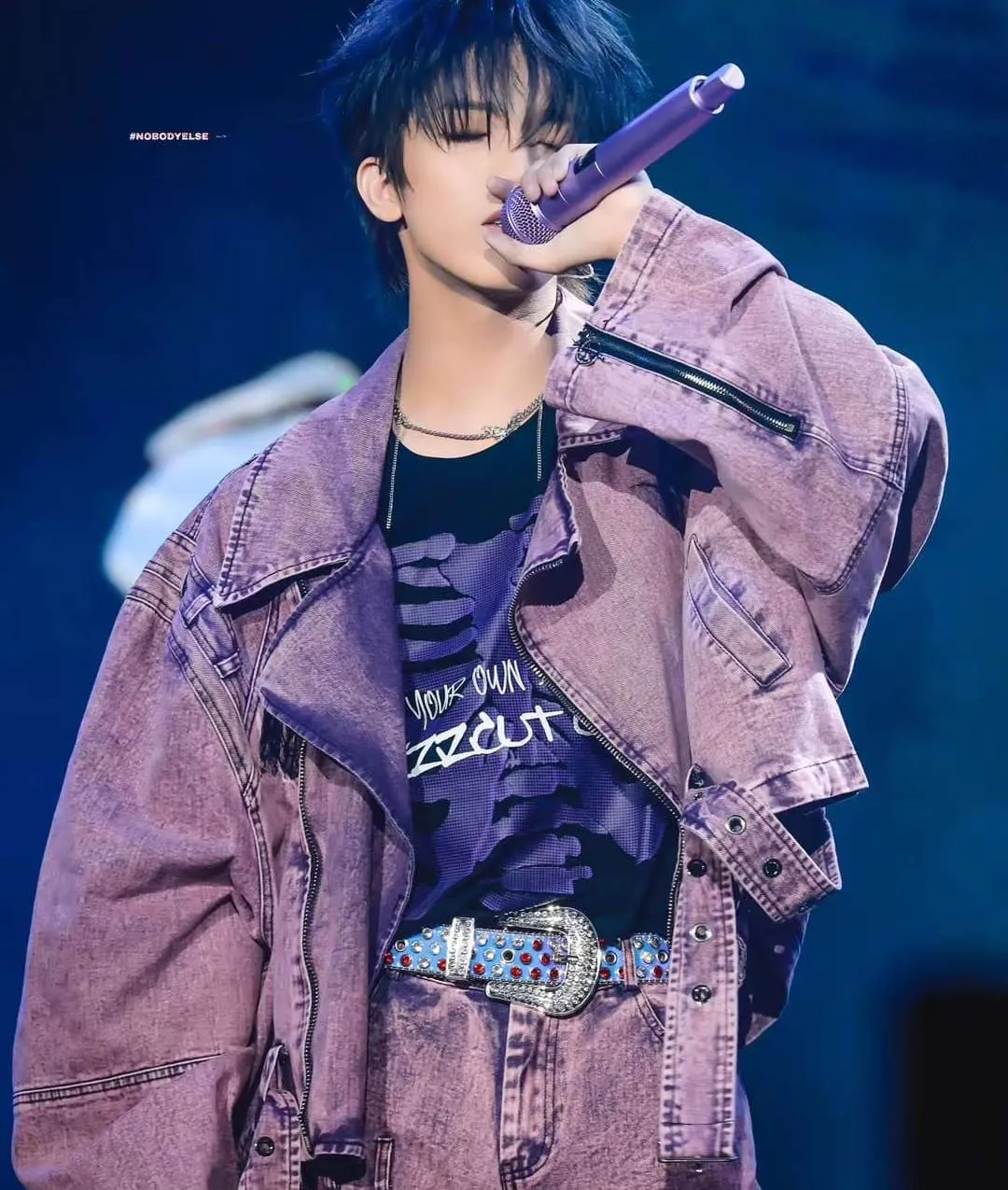 Performer on stage in a Pinkspink jacket